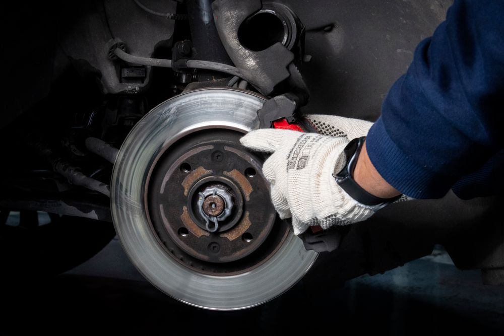 Gloved mechanic servicing a disc brake assembly