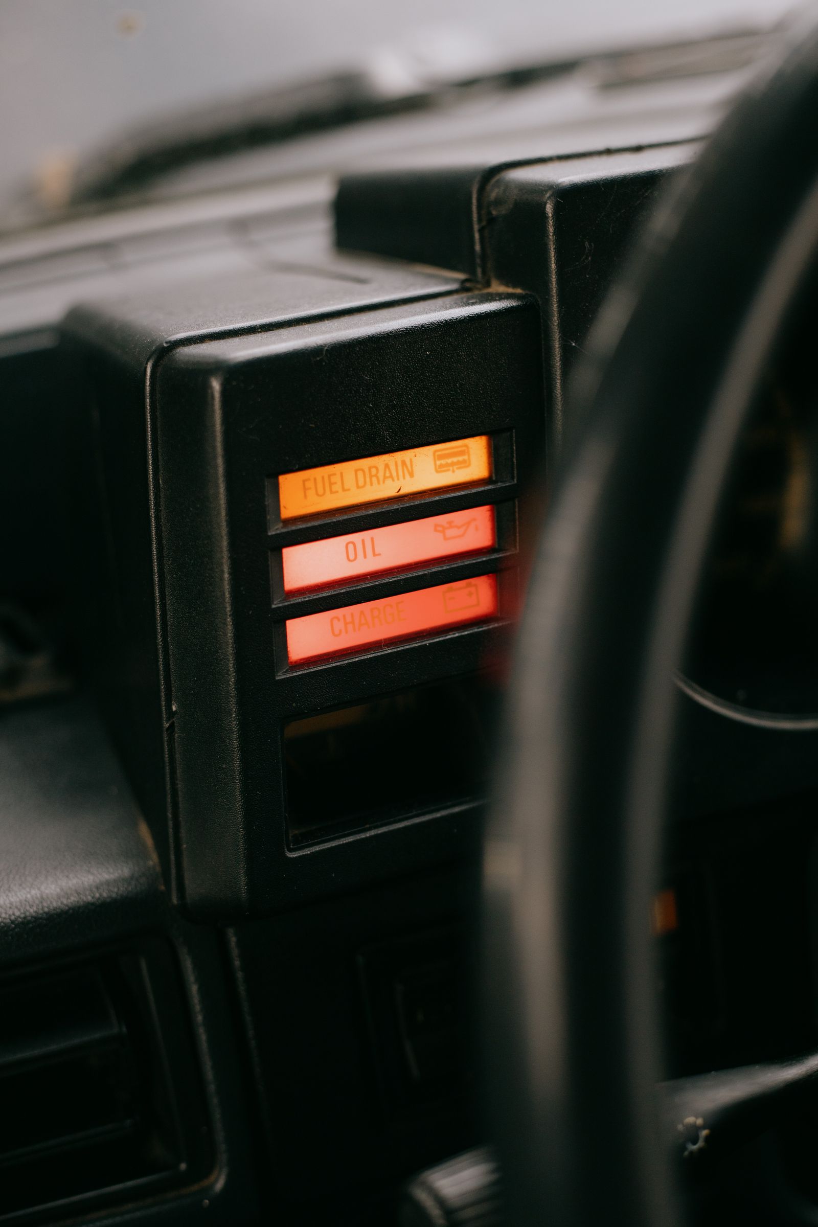 Vintage car dashboard with an illuminated oil indicator