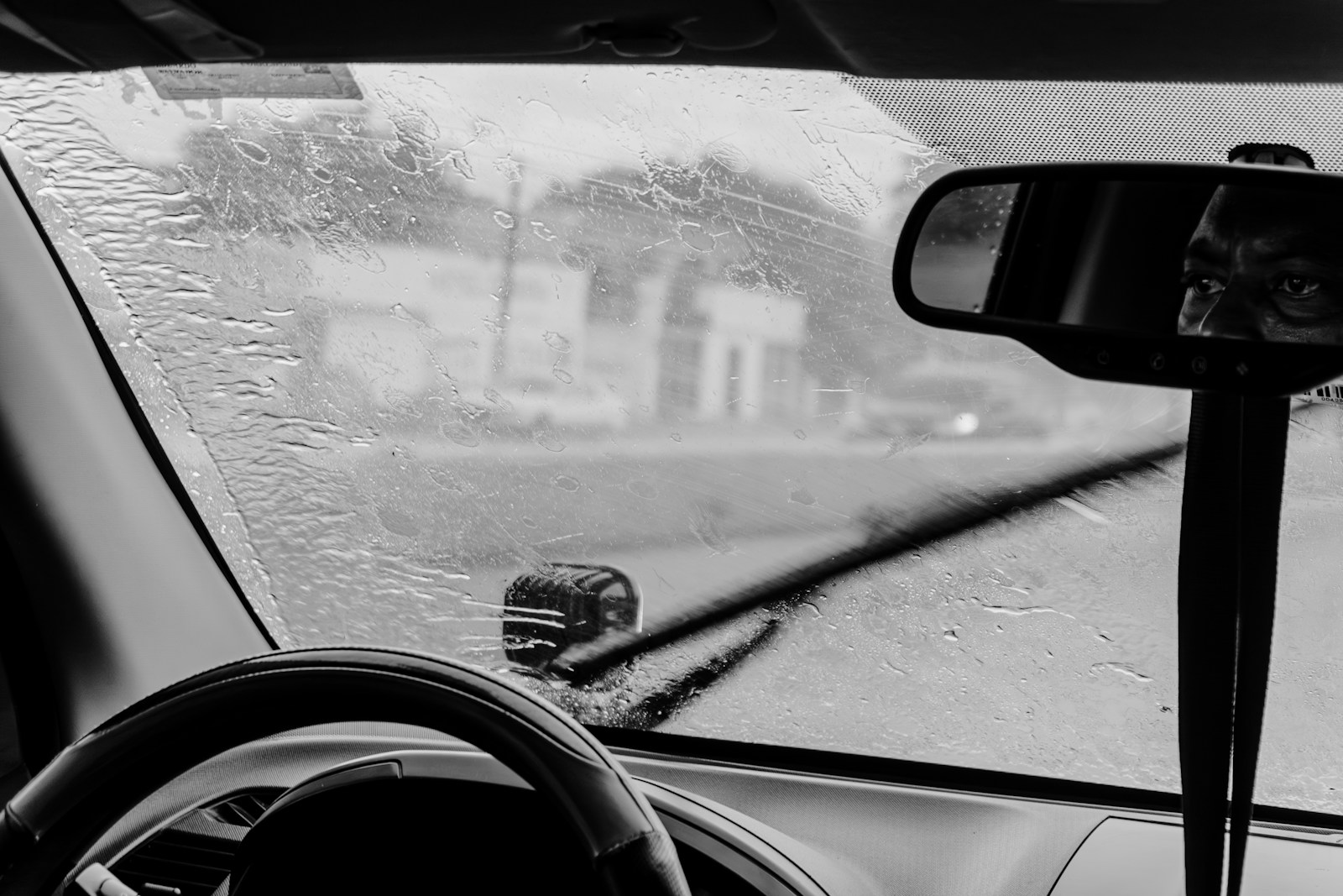 Windshield wipers clearing rain from a car window